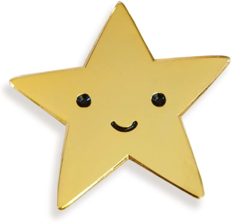 A gold metal star with a smily face etched into it