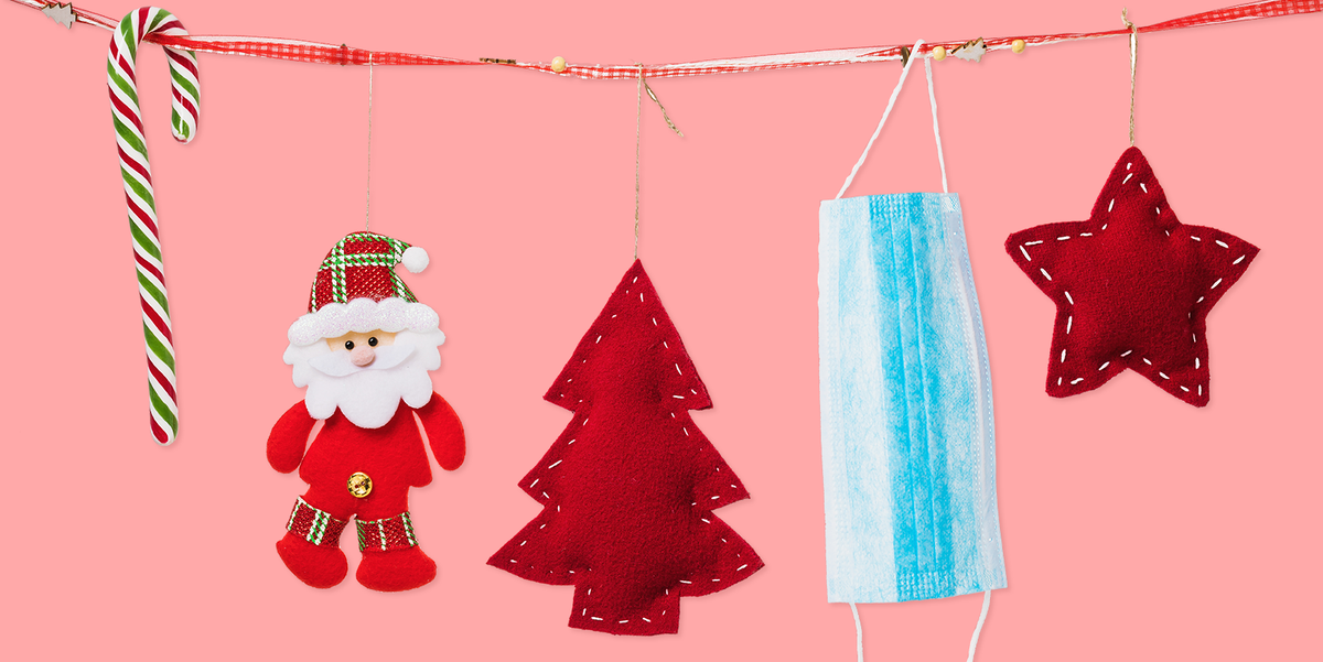 Christmas decorations hung on a string alongside a surgical face mask