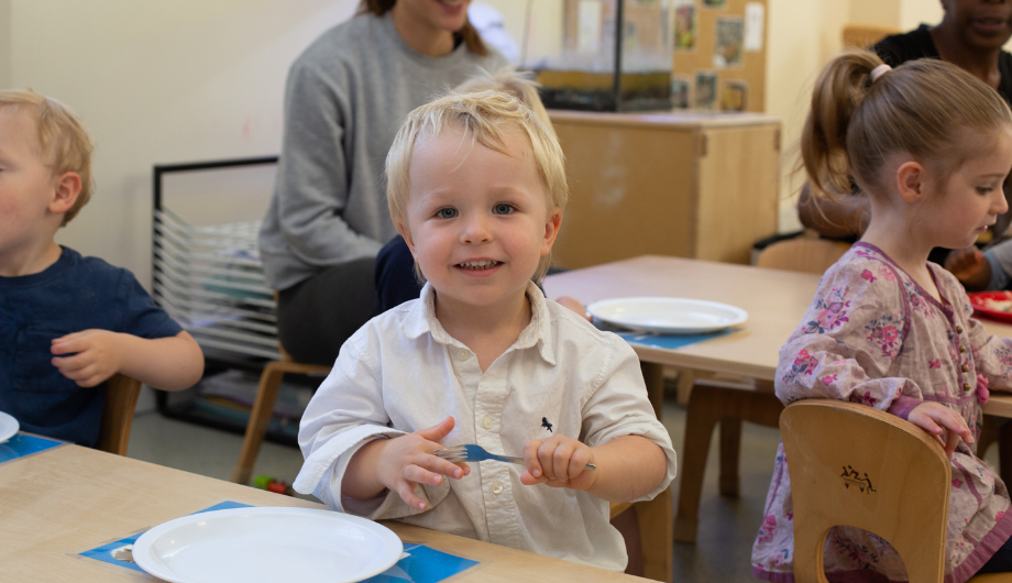 Child at lunchtime with fork