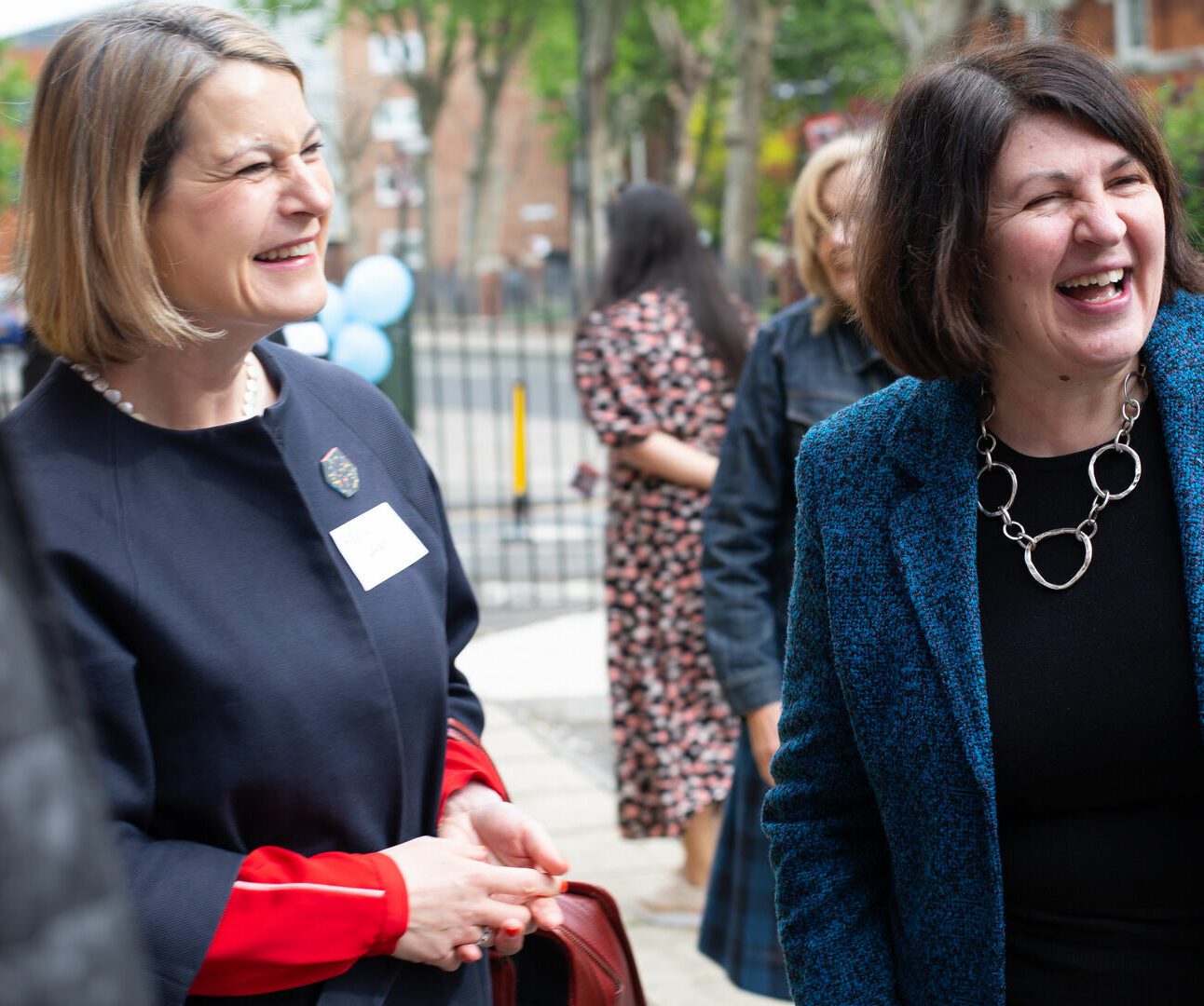 Photo of CEO and MP laughing at event