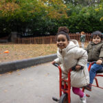 Playing on a bike at LEYF Brixton Gardens
