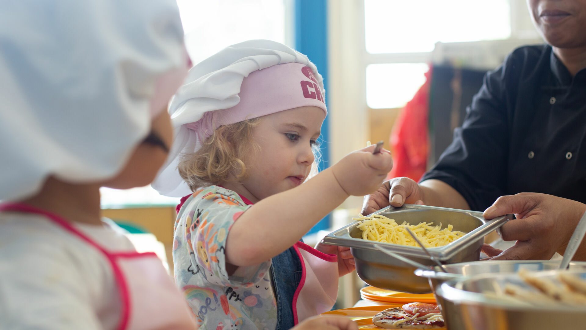 Children-sitting-down-for-a-meal-serving-themselves-
