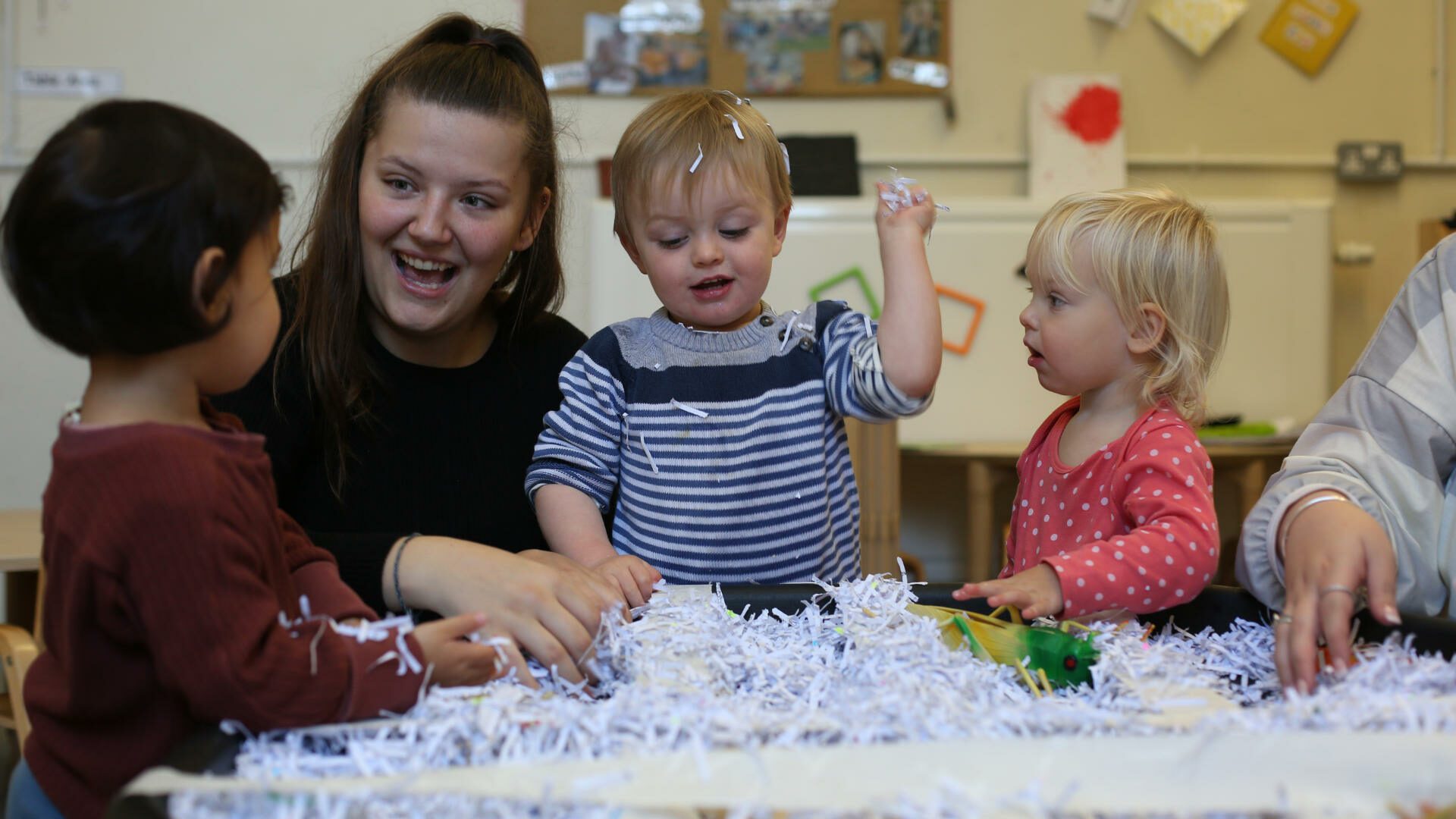 Children playing with shredded paper