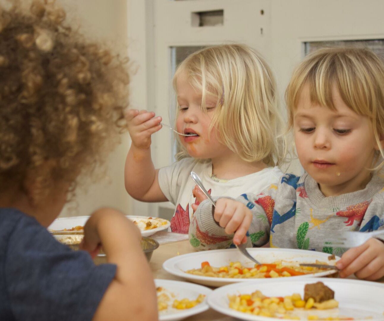 Children eating a meal in the nursery