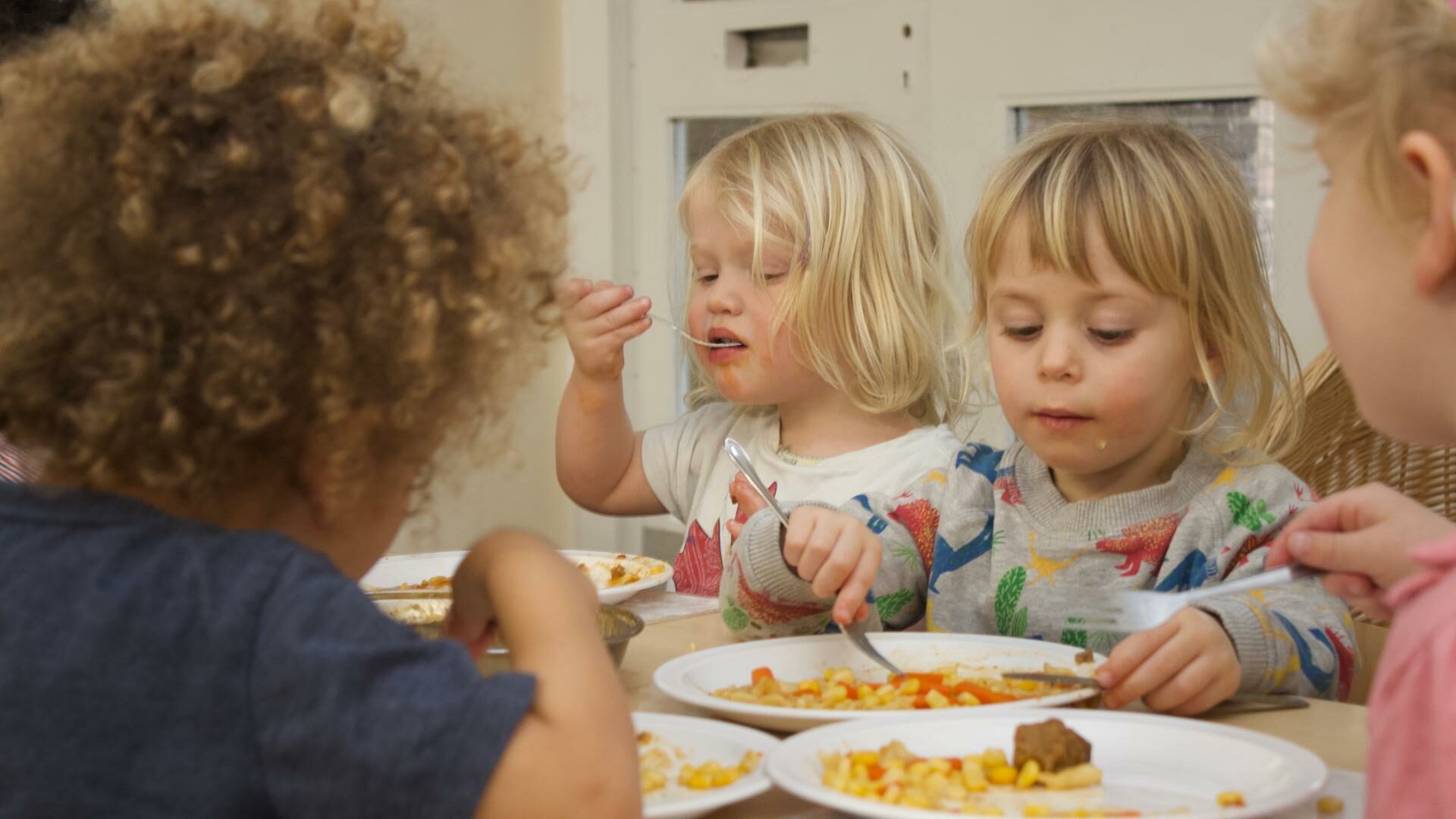 Children eating a meal in the nursery