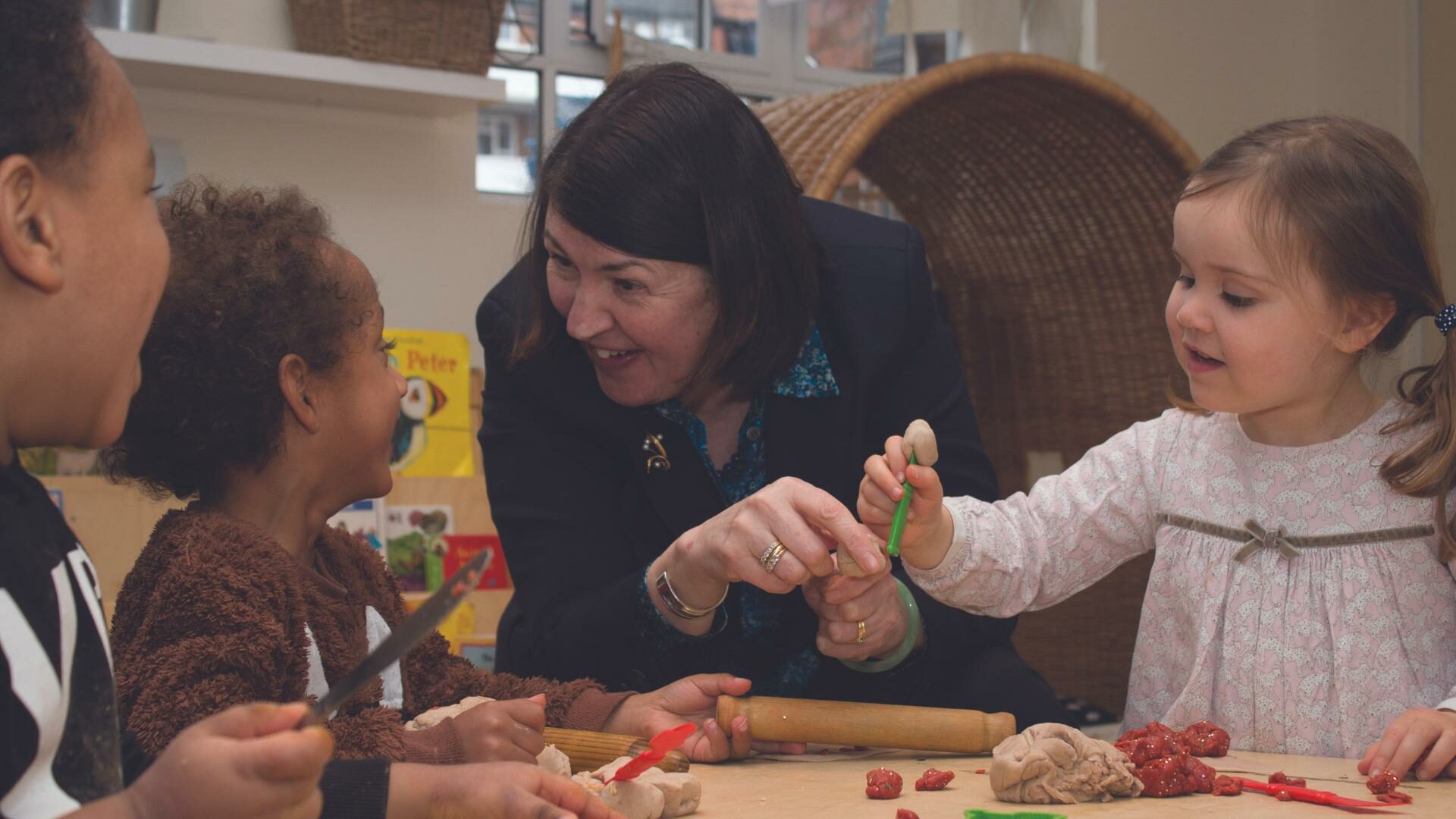 June at a nursery engaging in an activity with children