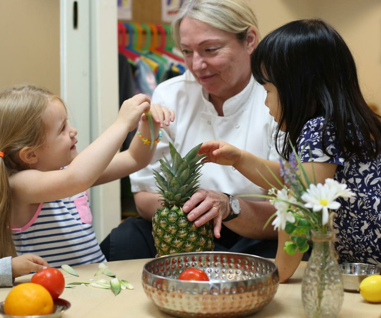 Children exploring different fruits with the nursery