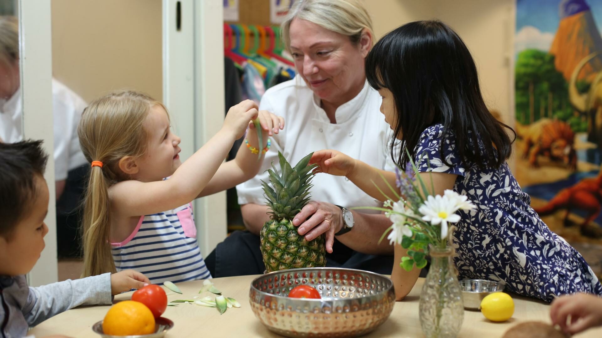 Children exploring different fruits with the nursery