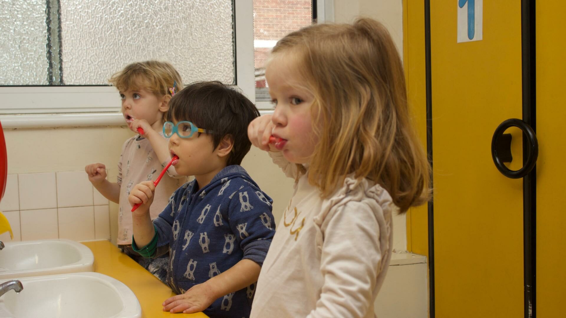 Children practicing how to brush their teeth after lunch