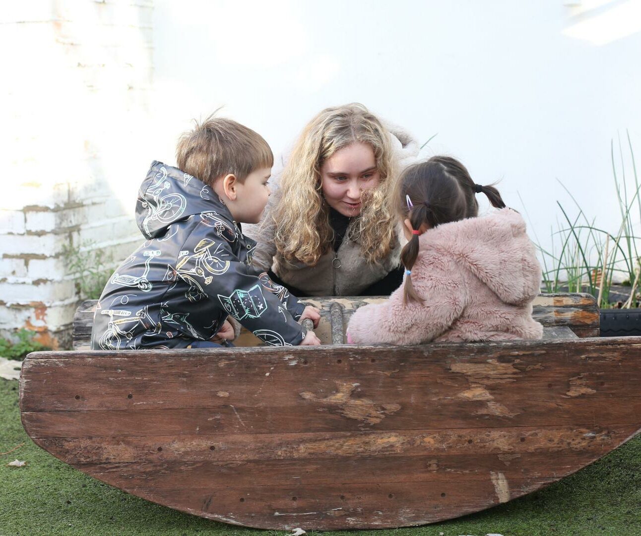 Children sitting on a see-saw like boat