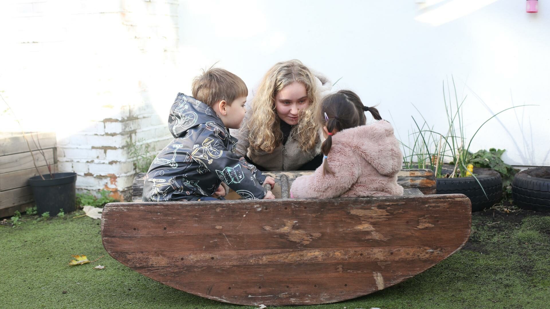 Children sitting on a see-saw like boat