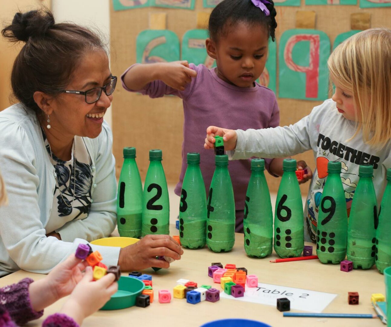 Staff and Children using creative ways to count