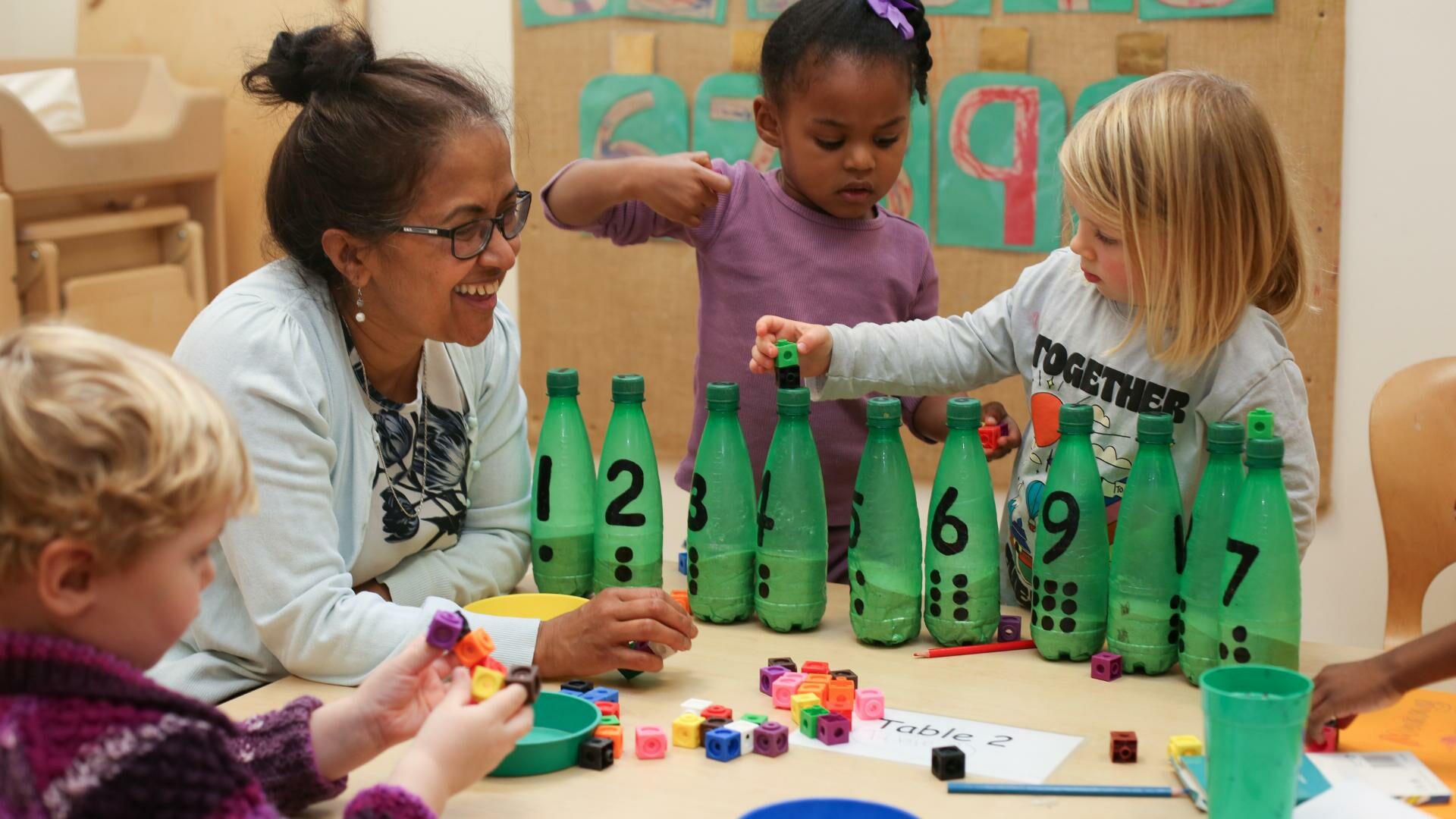 Staff and Children using creative ways to count