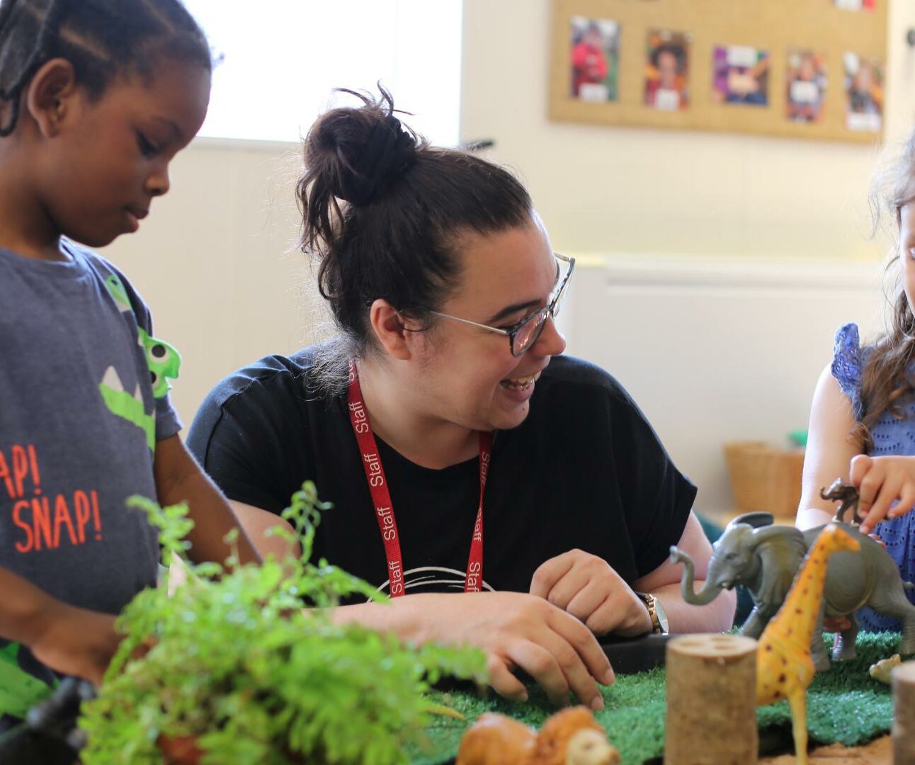 Staff and child playing with a provocation