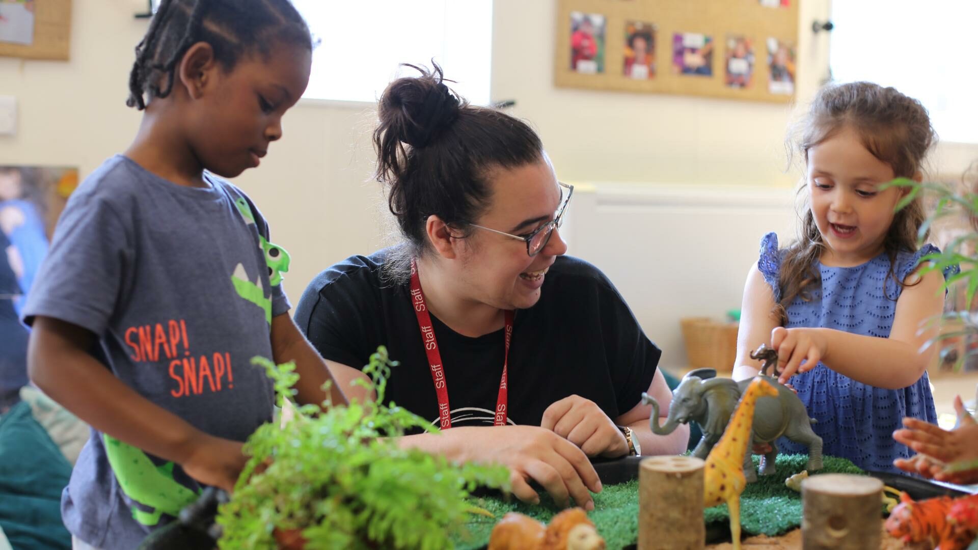 Staff and child playing with a provocation