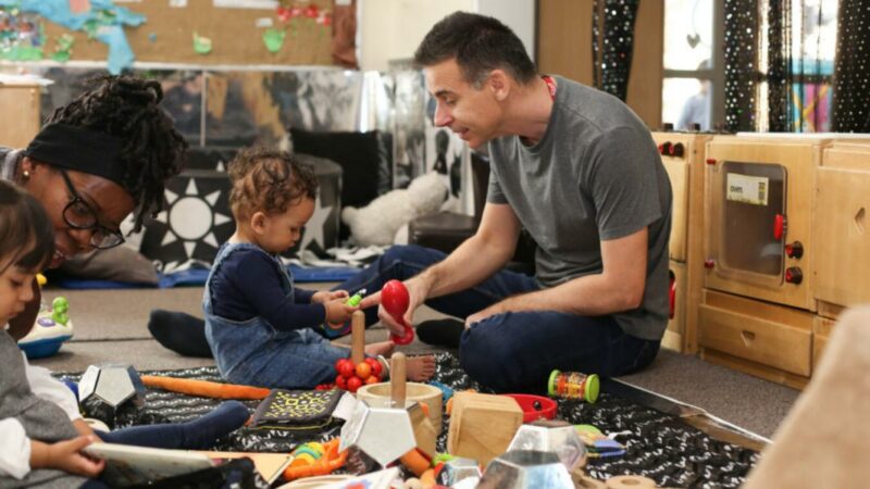 male staff using instruments with a baby