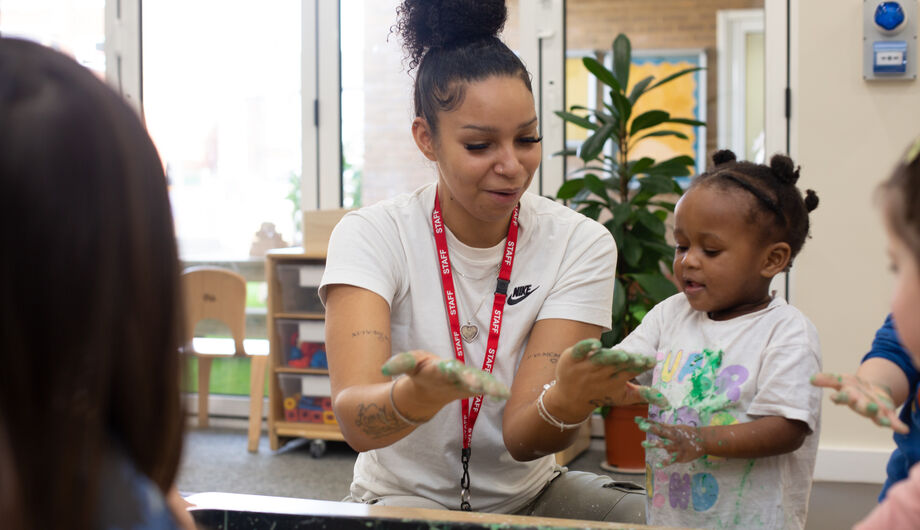 Teacher and children exploring messy slime activity.
