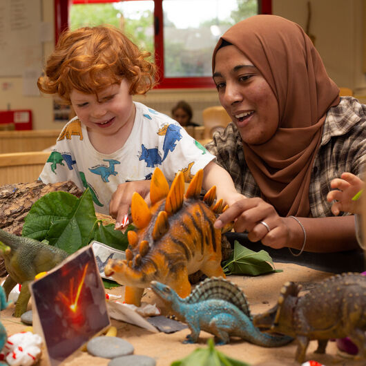 Children playing with dinosaurs and foam - Square