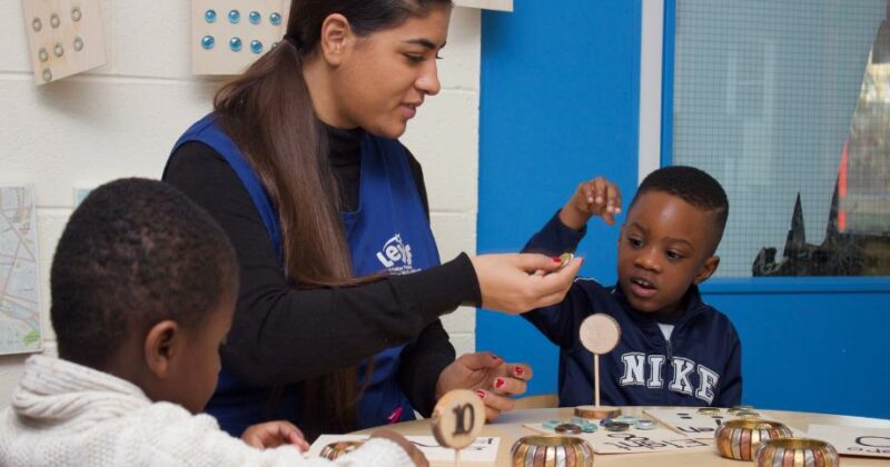 Staff member doing a counting exercise with children