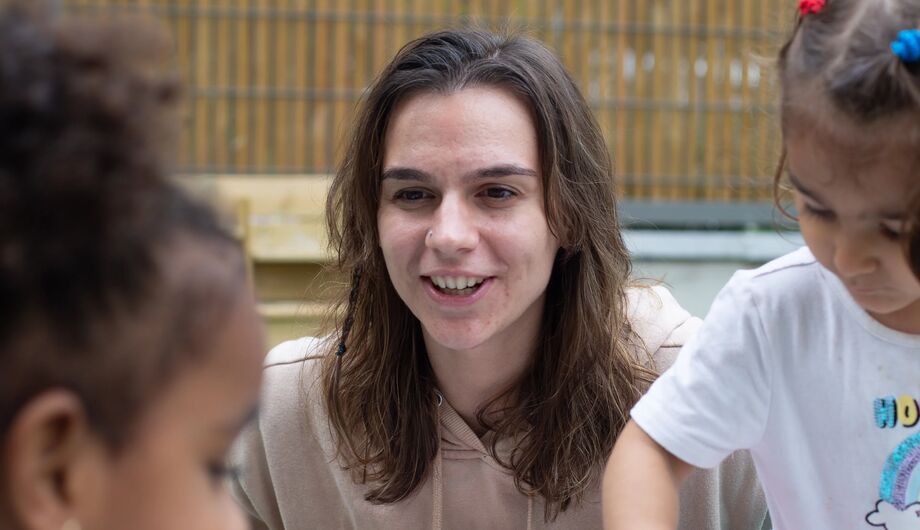 Teacher smiling at children