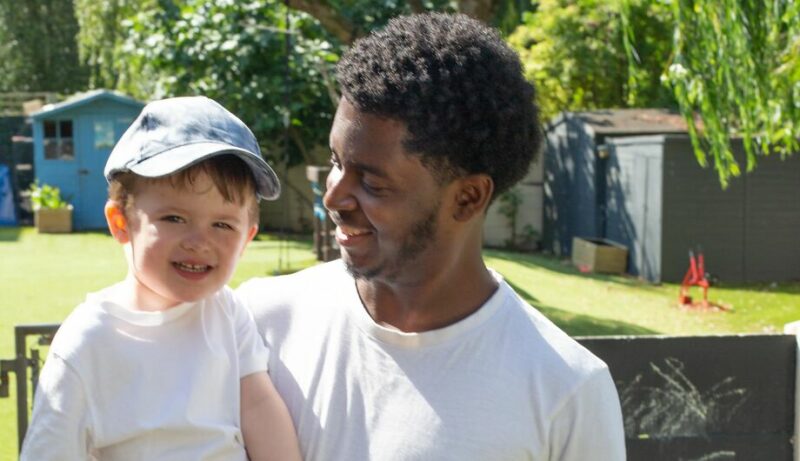 Male teacher smiling with a child