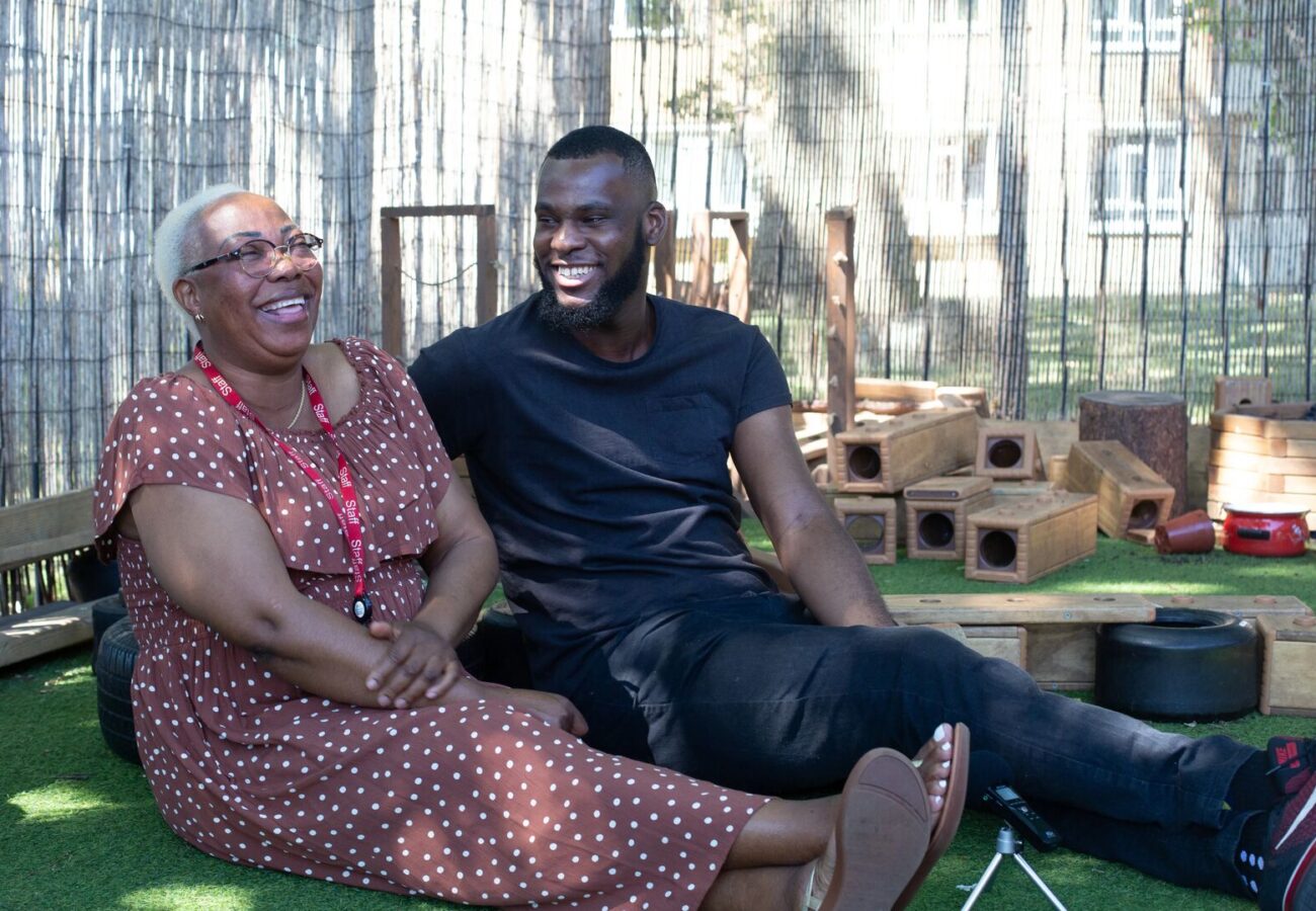 Two LEYF colleagues laughing together during a break, highlighting the friendly and supportive work environment