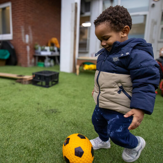 Children exploring outdoors at LEYF Nestles Avenue Nursery and Pre-School