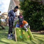 Children exploring the outdoors at LEYF South Ruislip Nursery and Pre-School
