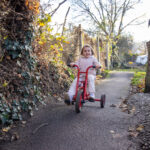 Playing on a bike at LEYF Nestles