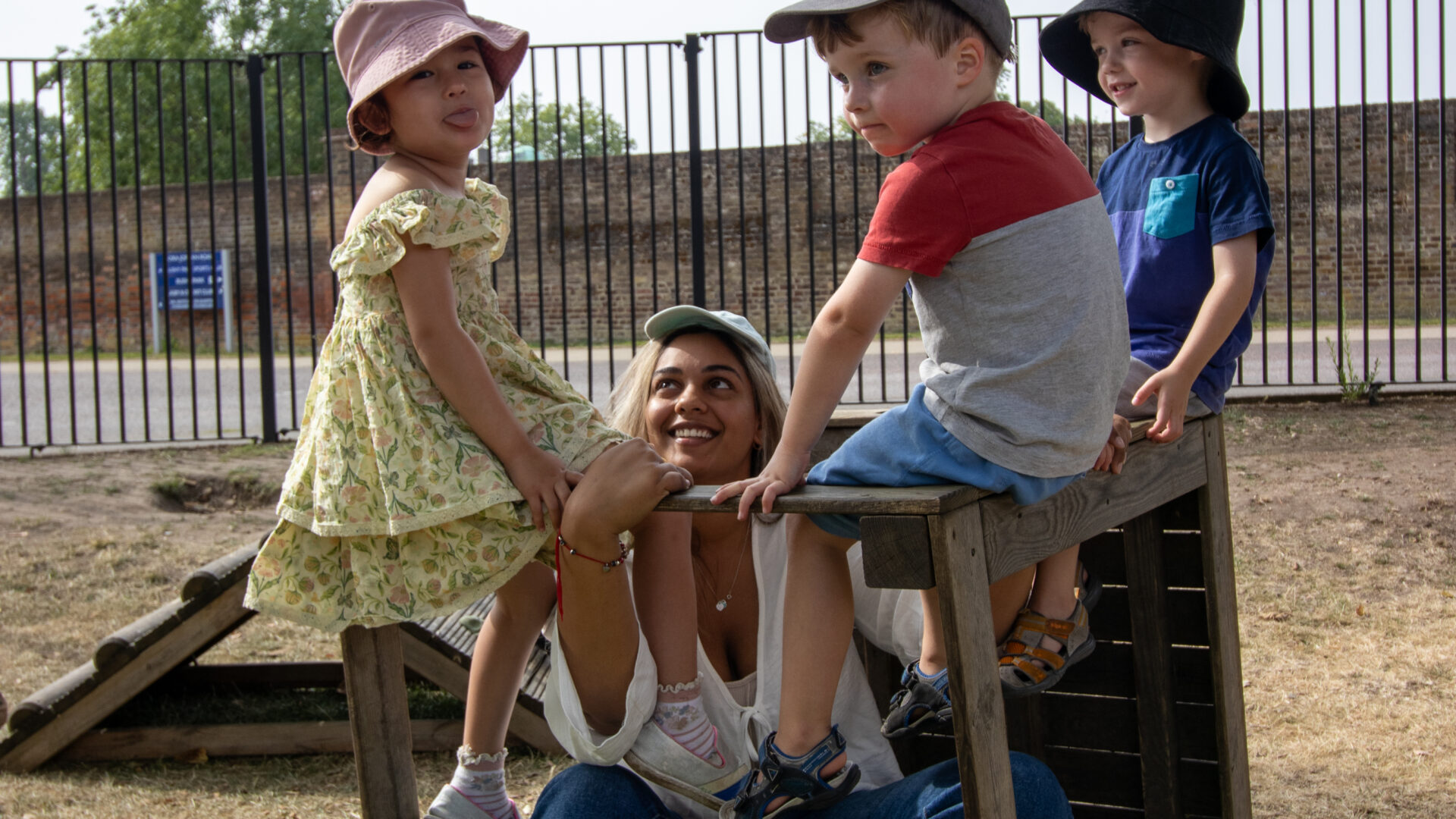 Pre-Schoolers in the garden singing songs on a structure