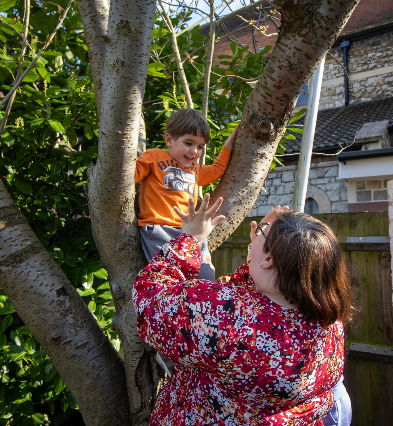 Burgess Park Teacher Manager Educator Practitioner helping child climb tree.
