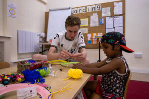 A LEYF Apprentice teaching crochet