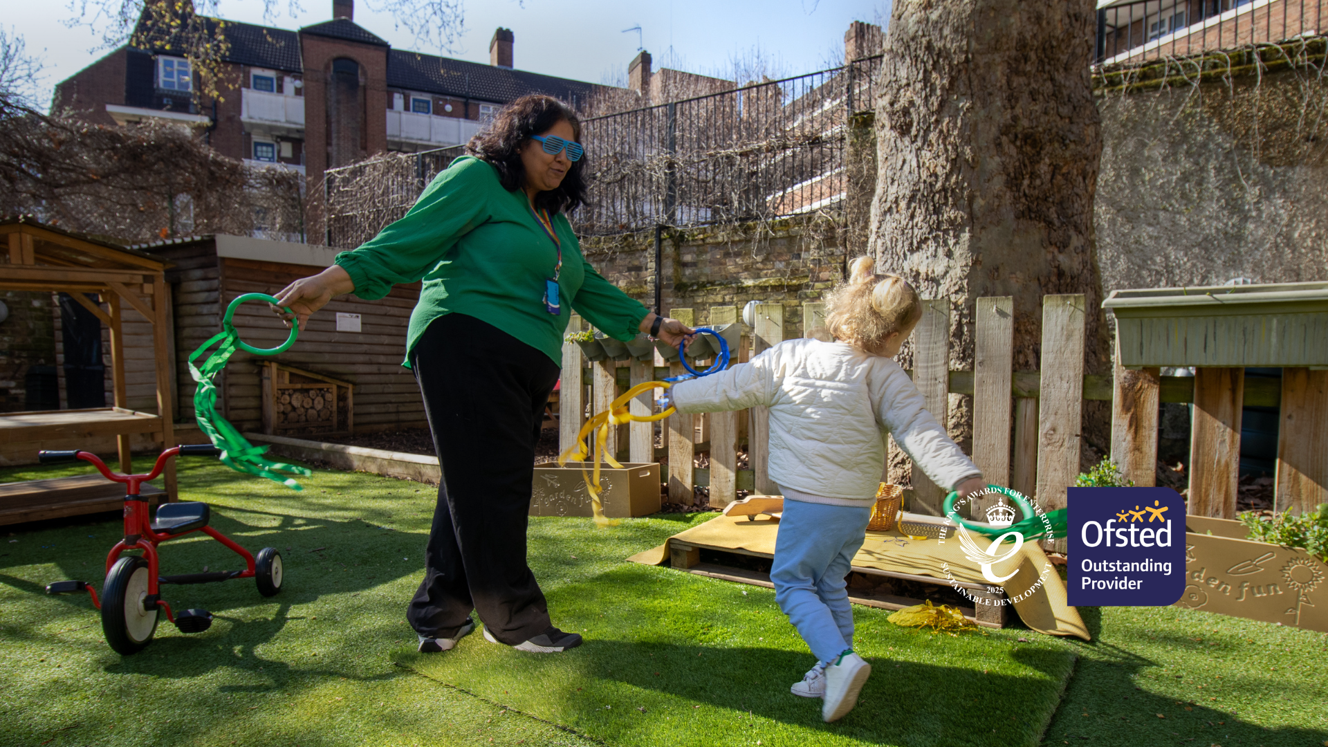 LEYF Nursery Teacher dancing with student. Homepage banner.